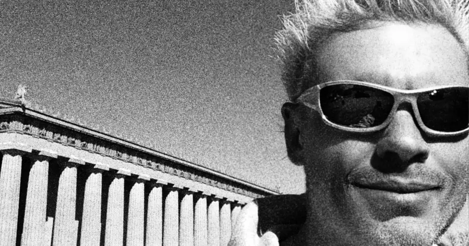 Black and white photo of David Faulkner wearing sunglasses in front of the Nashville Parthenon